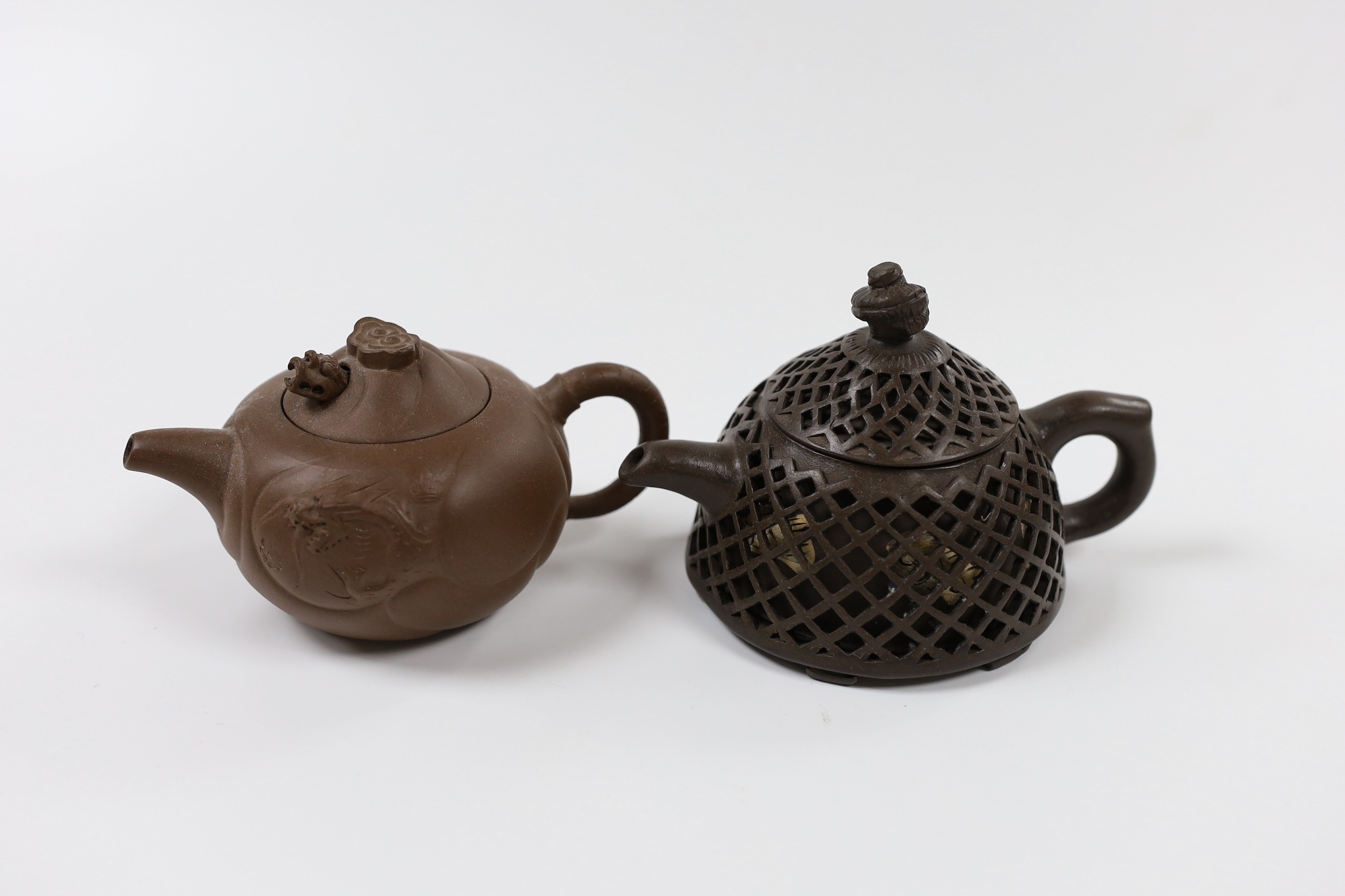 A Chinese Yixing reticulated teapot and cover and another